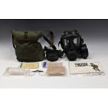 A cold war gas mask and accessories in bag.
