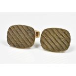 A pair of 9ct yellow gold cufflinks of oval form with engine turned decoration, 10g.