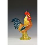 A large Italian glazed terracotta Cockerel 21½in. (54.5cm.) high.