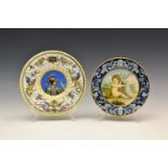 An 18th / 19th century Italian faience / maiolica plate painted with a seated putto holding a