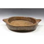 A large rustic wooden twin handled dough / dairy bowl 25¼in. (64.2cm.) handle to handle.