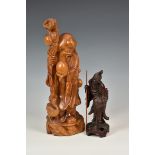 A modern Chinese style carved wooden figure of an Immortal, 16½in. (42cm.) high,