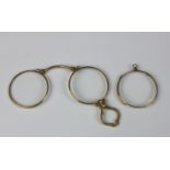 A pair of rolled gold lorgnettes with bark effect hinged nose piece and fancy handle,