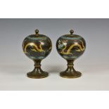 A pair of Chinese cloisonné pedestal jars and covers black ground, depicting dragons