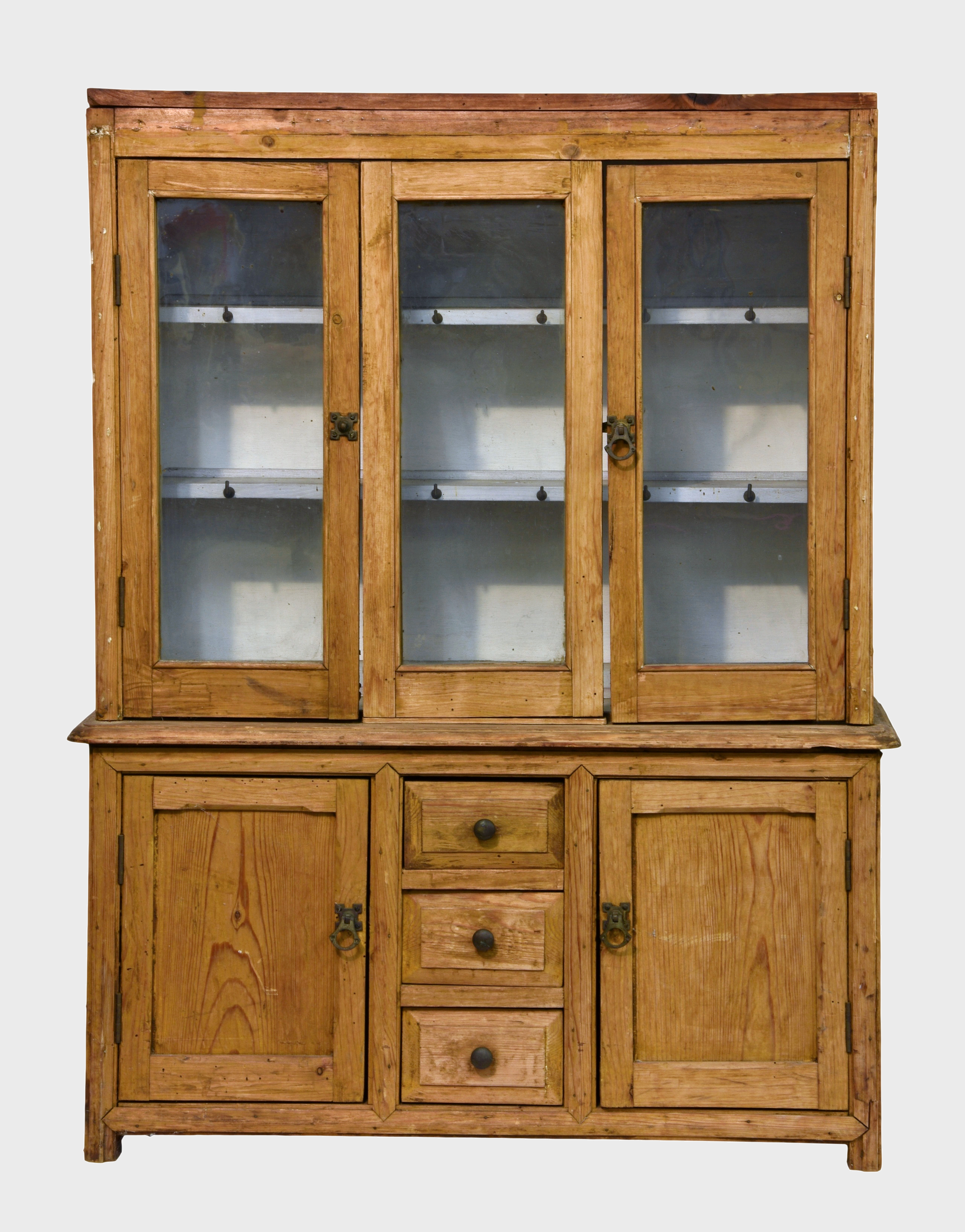 An early 20th century scratch-built bleached pine child's glazed dresser, of typical form, having