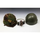 Two Military helmets and a pair of earphones.