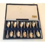 A cased set of ten silver plate & enamel Guernsey parish teaspoons.