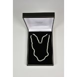 A 16in. cultured pearl necklace with silver clasp.