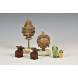 A small collection of Oriental figures to include terracotta style buddha heads, carved wooden