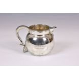 A George VI silver baluster cream jug Edward Barnard & Sons Ltd., London 1935, with leaf capped