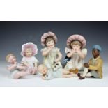 A collection of early 20th century bisque piano dolls