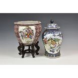 A modern Chinese style fish bowl and stand decorated with three reserves of figures in landscape