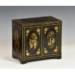 A Chinese lacquer table cabinet 19th century, the pair of cupboard doors enclosing an arrangement
