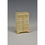 A miniature ivory tallboy early 20th century, 4¾in. (12.1cm.) high.