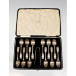 A cased set of twelve bright cut fiddle pattern teaspoons & tongs W S Savage & Co, Sheffield, 1930,