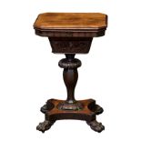 A William IV rosewood work table, the hinged, bevelled rectangular top with clipped corners, over