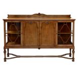 A matching part-glazed sideboard or drinks cabinet, 1930s, with a central two door cupboard with