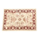 An Indian Zeigler style rug, purchased from Harrods, late 20th century, the ivory ground with single
