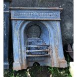 A Victorian cast iron fireplace with grate insert,