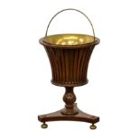 A Regency style mahogany basket shaped jardiniere, late 20th century, of campagna urn form, the