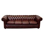 A Chesterfield four seater buttoned red leather settee, 94in. (239cm.) long.