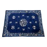 A large antique Chinese blue ground rug, possibly Beijing, 1st quarter 20th century, the dark blue