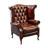 A Georgian style buttoned red leather library chair, on beechwood cabriole style legs, 36¾in. (93.