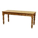 A modern scrubbed pine farmhouse style serving table, the rectangular top over a single plain frieze