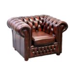 A Chesterfield buttoned red leather armchair, 42in. (106.5cm.) wide.