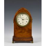 An early 19th century arched inlaid mahogany mantel clock by Widenham of London, with signed