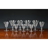 A suite of twenty four (24) Waterford crystal glasses, each with panel cut trumpet bowls on