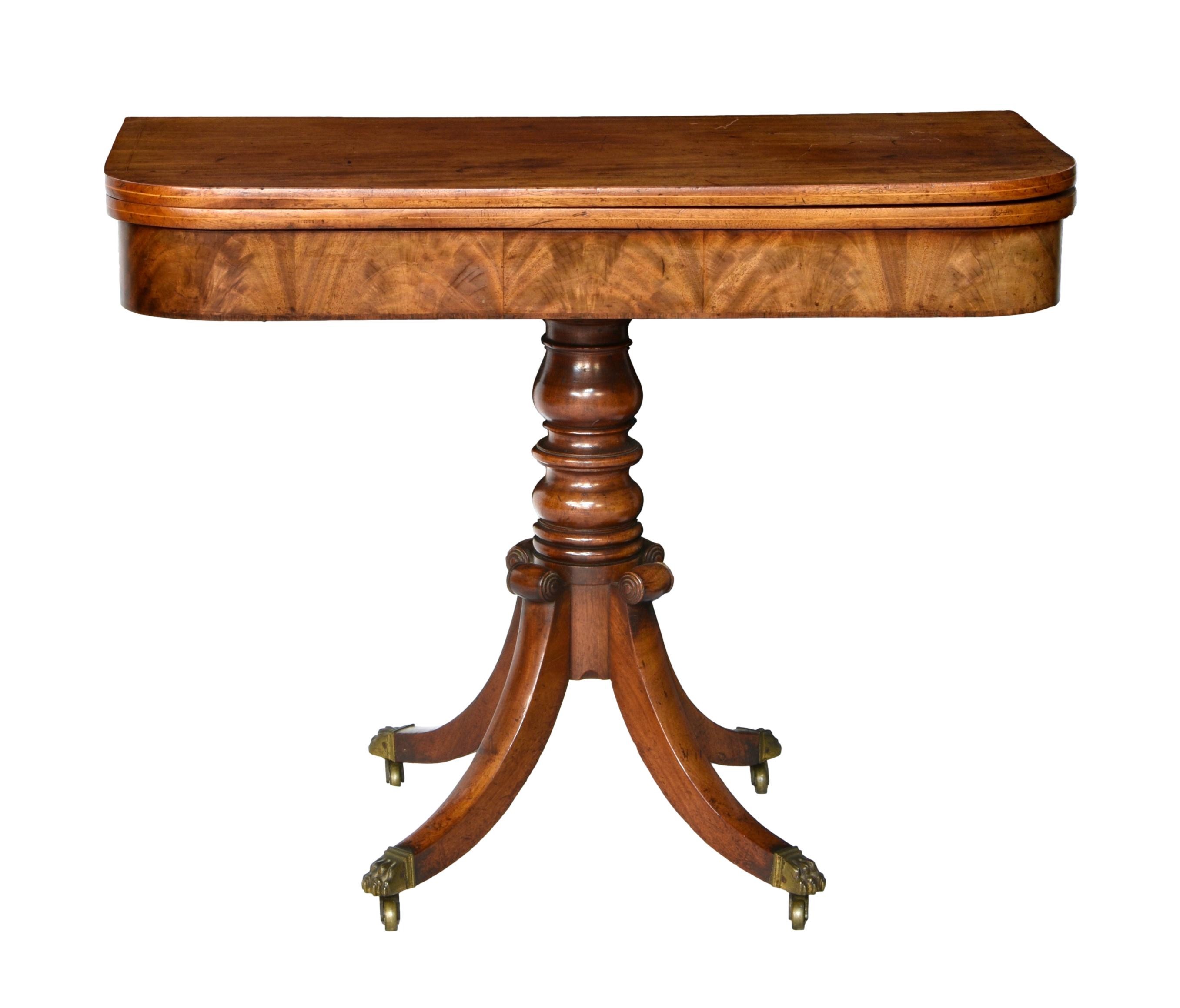A late-Regency D-shaped mahogany tea table, the boxwood strung top over a rosewood edge banded