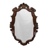 A carved oak 18th century style mirror, early 20th century, cartouche form, the moulded frame carved