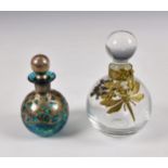 Two vintage glass scent bottles, the larger of spherical clear glass form with applied gilt metal
