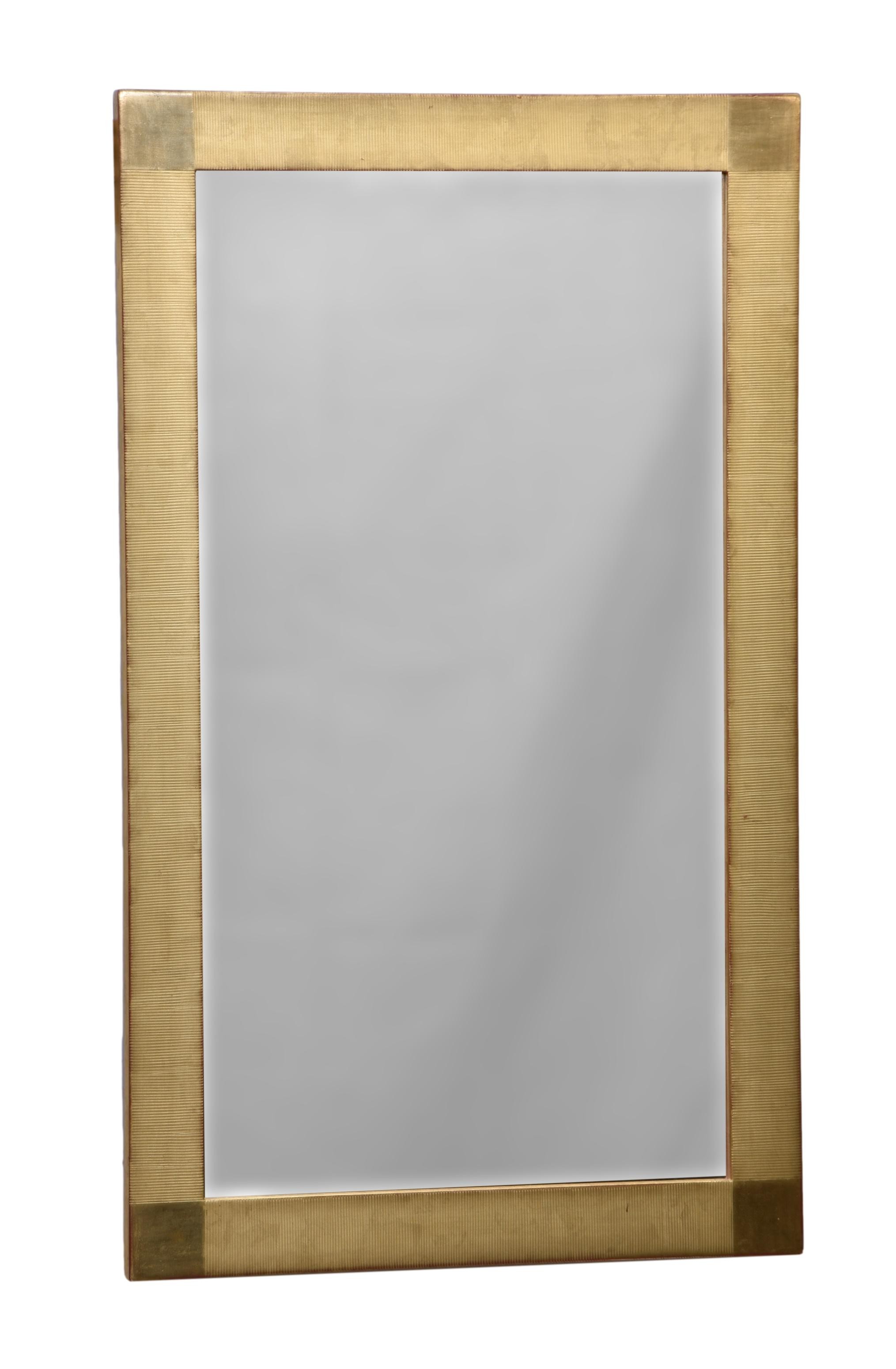 A modern giltwood mirror, the ribbed gilt frame with plain gilt squares to the angles, 24 x 39½