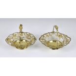 A matched pair of George III silver-gilt pierced baskets, maker's marks indistinct, London 1766 &