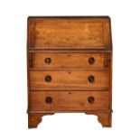 An Arts & Crafts style oak bureau, the fall enclosing a simple fitted interior with two drawers