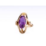 A 14ct rose gold and amethyst dress ring, the oval cut amethyst held in a 4 pronged setting on an