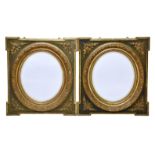 A pair of late Victorian giltwood and composition picture frame mirrors, the later oval bevelled