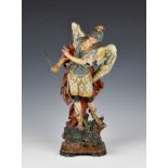 A 19th century painted and gilded terracotta figure of St Michael the Archangel slaying the