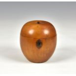 A 19th century fruitwood apple tea caddy, having metal hinge and escutcheon, the cover with