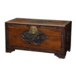 A carved and part-ebonised camphorwood chest, 1930s, the lid, front and sides with fan shaped