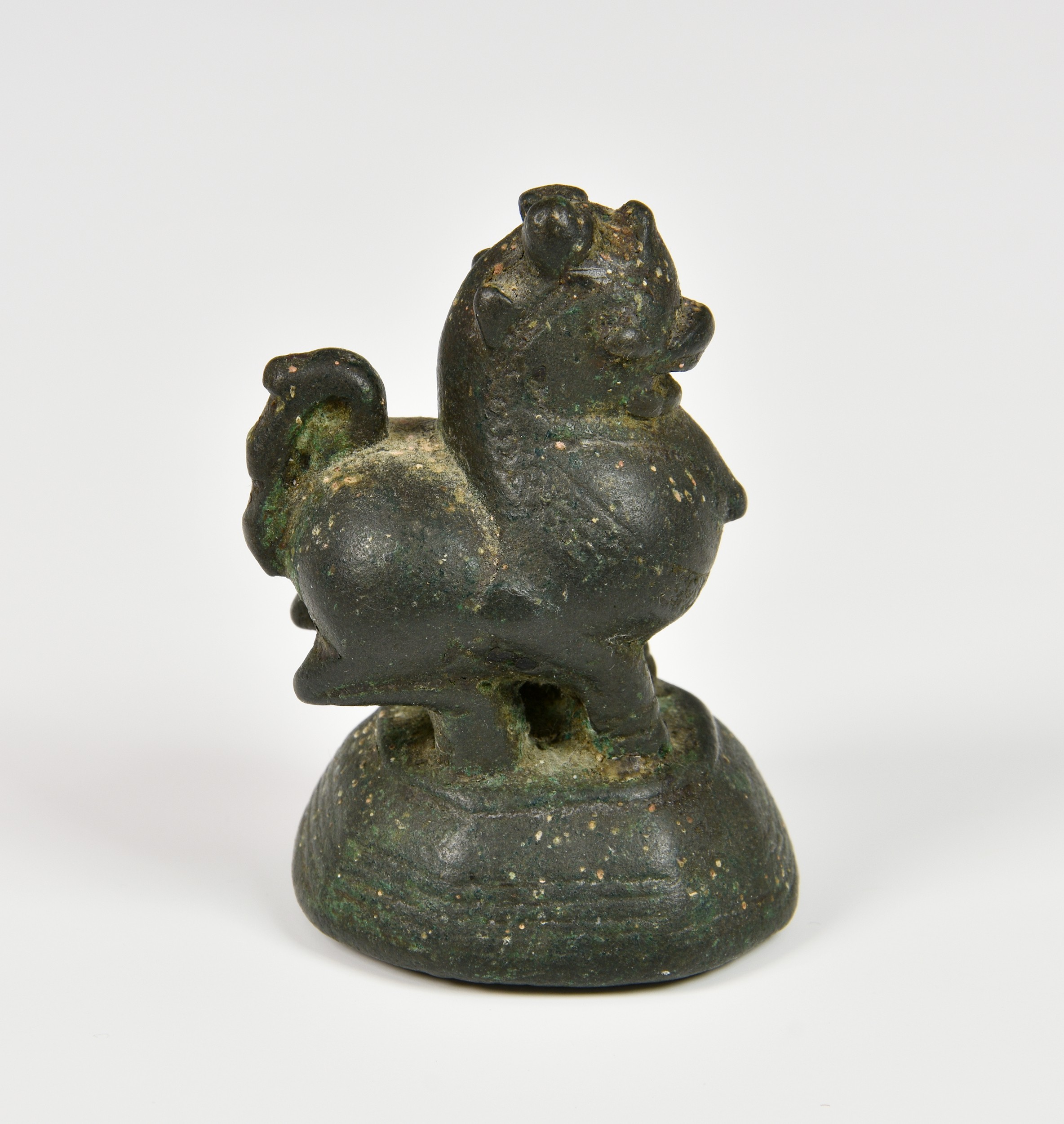 An 18th / 19th century Burmese cast bronze opium weight, in the form of Chinthe, raised on a