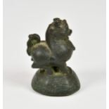 An 18th / 19th century Burmese cast bronze opium weight, in the form of Chinthe, raised on a