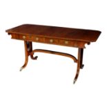 A fine George IV 'plum pudding' mahogany sofa table, the rectangular top with cut corner drop leaves