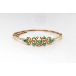 A Victorian 15ct gold, turquoise and pearl bangle, with horseshoe and foliate motif, internal