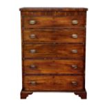 A mid-19th century tall mahogany five drawer chest, with five long graduated drawers with later oval