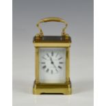 A miniature brass carriage clock by Elliott & Son, London, 20th century, with five bevelled glass