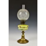 A 19th century oil lamp, with a floral painted green glass reservoir above a turned brass base,