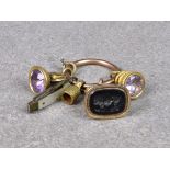 A base metal split ring with various 9ct and 15ct gold charms/fobs, to include two amethyst based